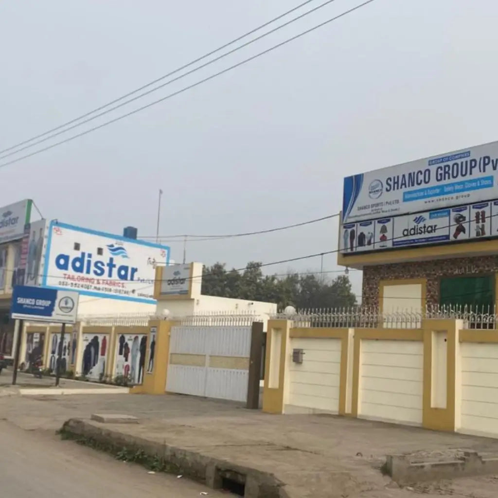 Commercial buildings with Adistar and Shanco Group signage on a clear day.